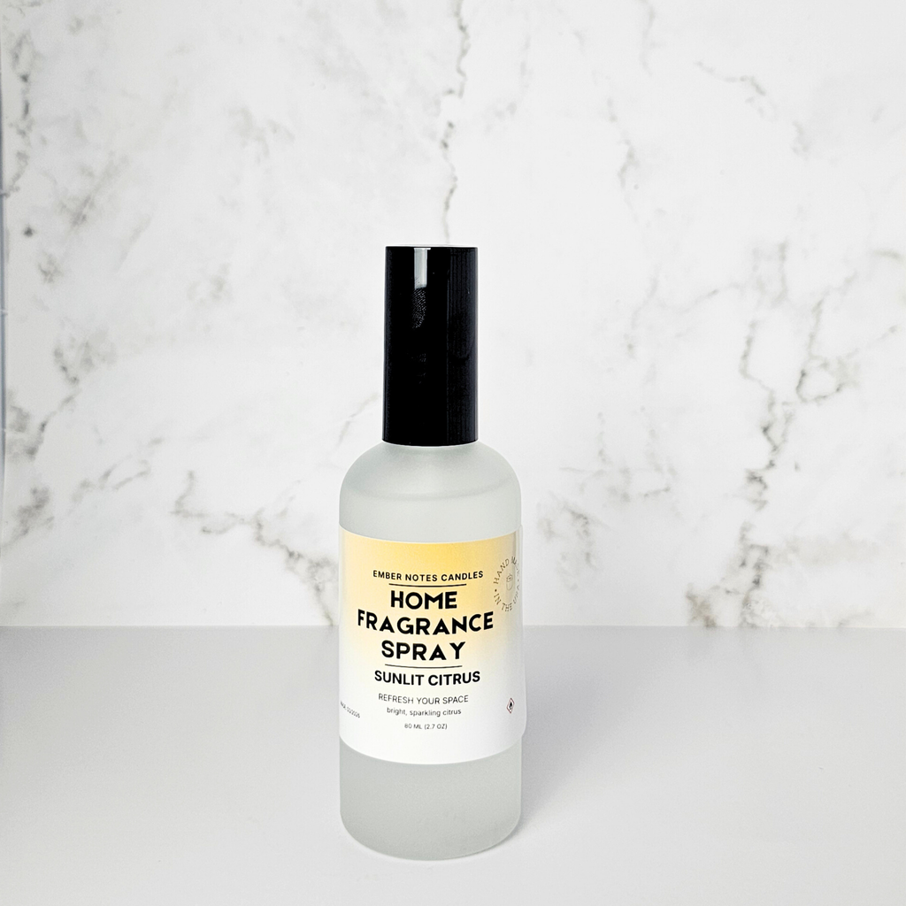 Home fragrance spray bottle with a yellow label on a marble background