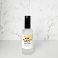 Home fragrance spray bottle with a yellow label on a marble background