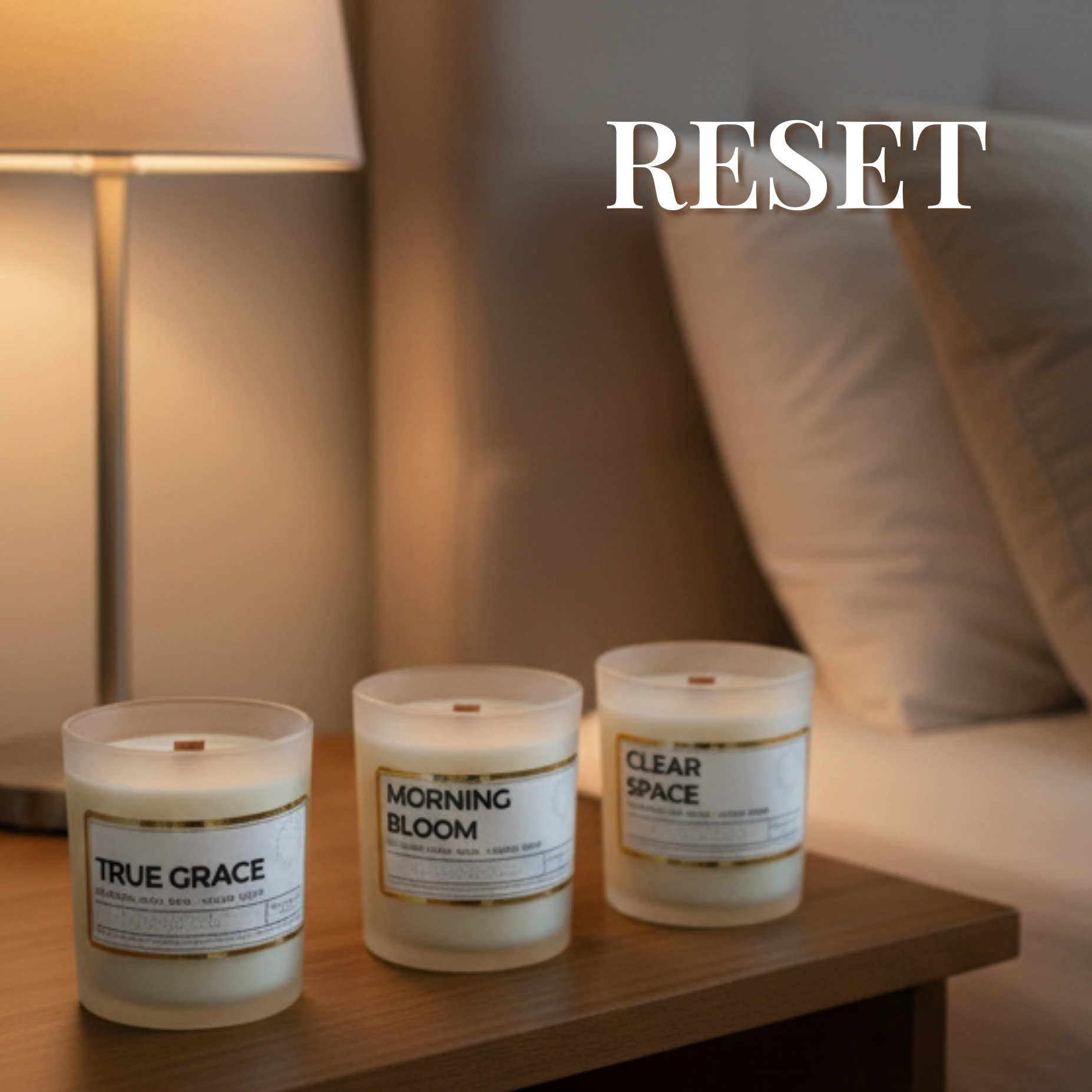 ember notes candles sitting on a table next to a bed