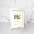 Sunlit Citrus wax melt packaging on a marble background