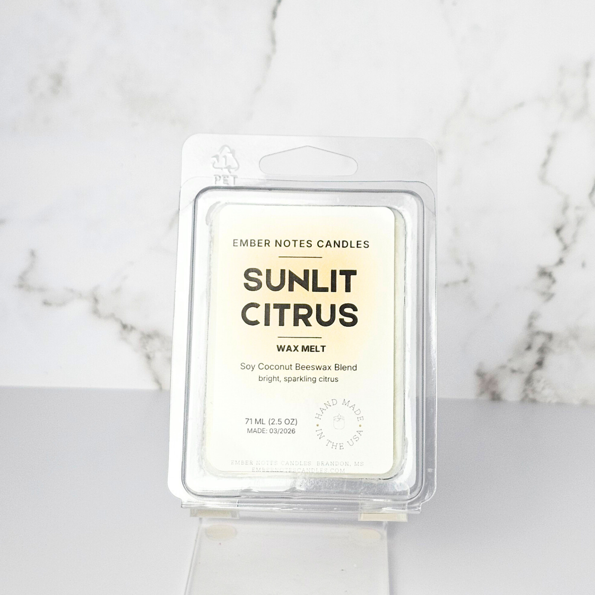 Sunlit Citrus wax melt packaging on a marble background