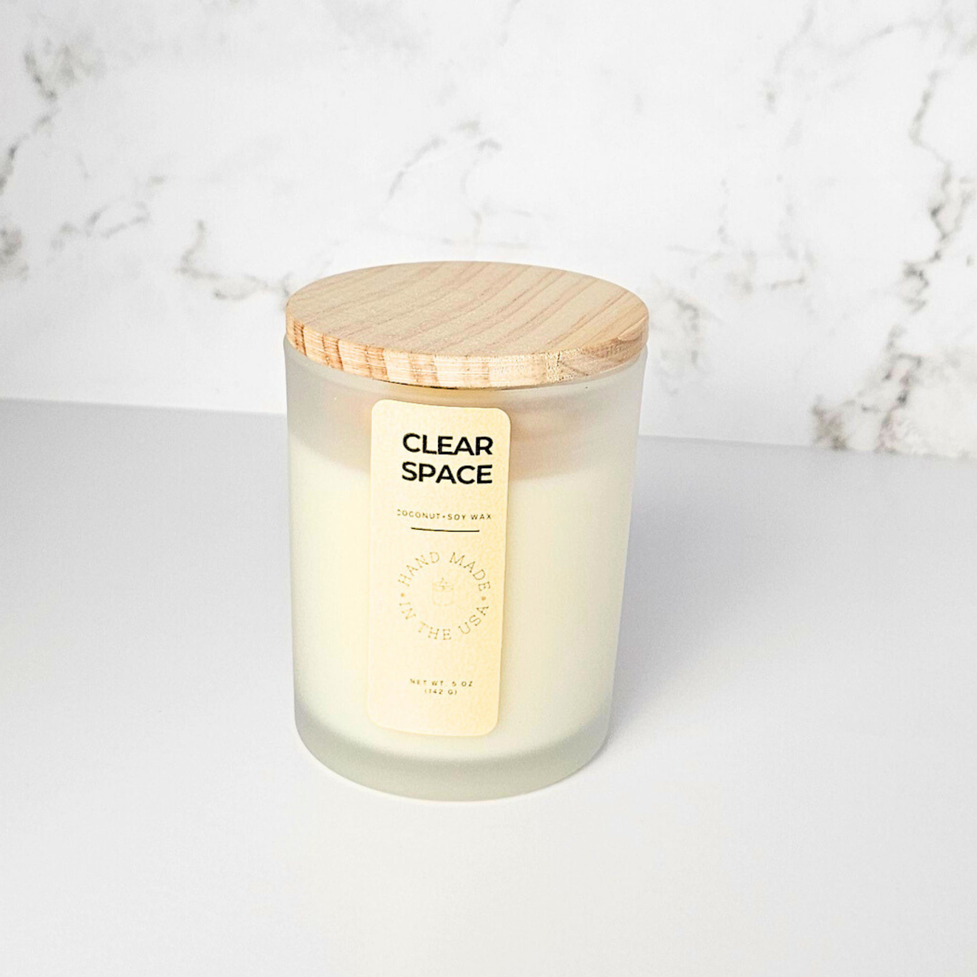 Wickless candle with wooden lid on a marble background