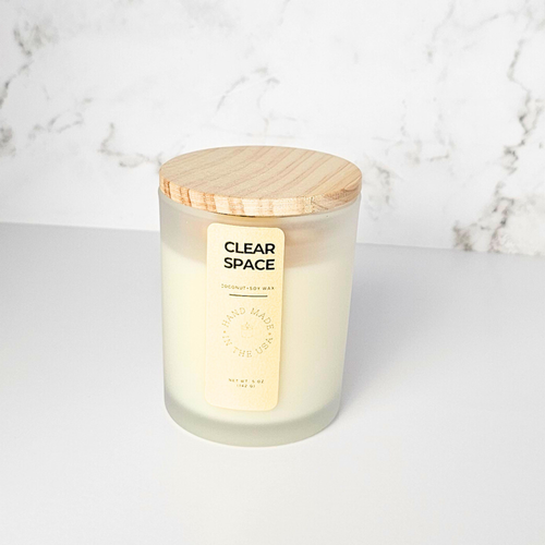 Wickless candle with wooden lid on a marble background