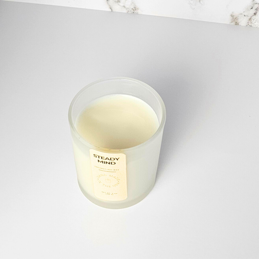 Wickless candle labeled 'Steady Mind' on a white surface