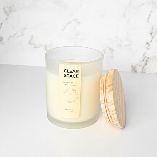 Wickless Candle labeled 'Clear Space' with a wooden lid on a marble surface