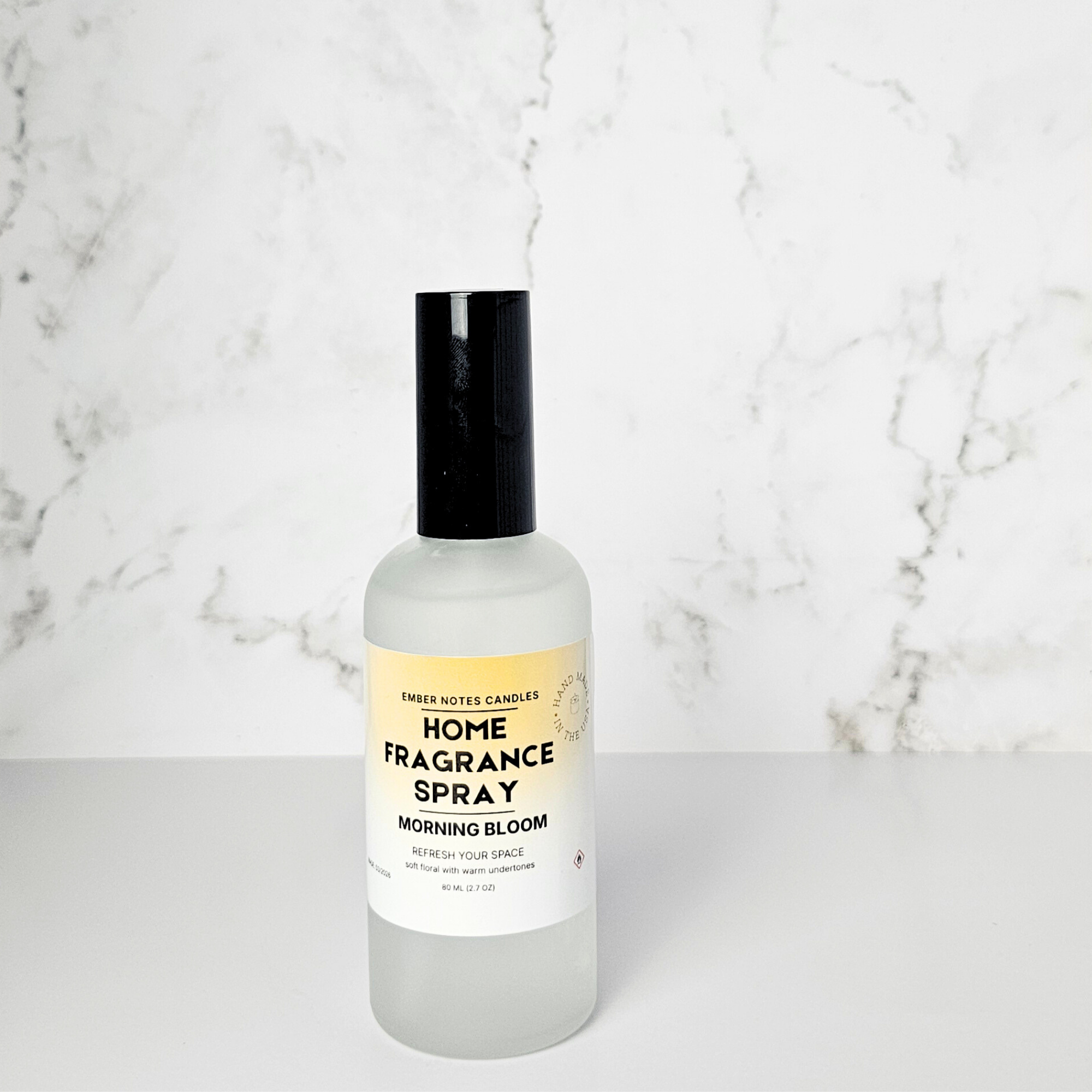 Home fragrance spray bottle labeled 'Morning Bloom' on a marble surface