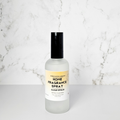 Home fragrance spray bottle on a marble surface