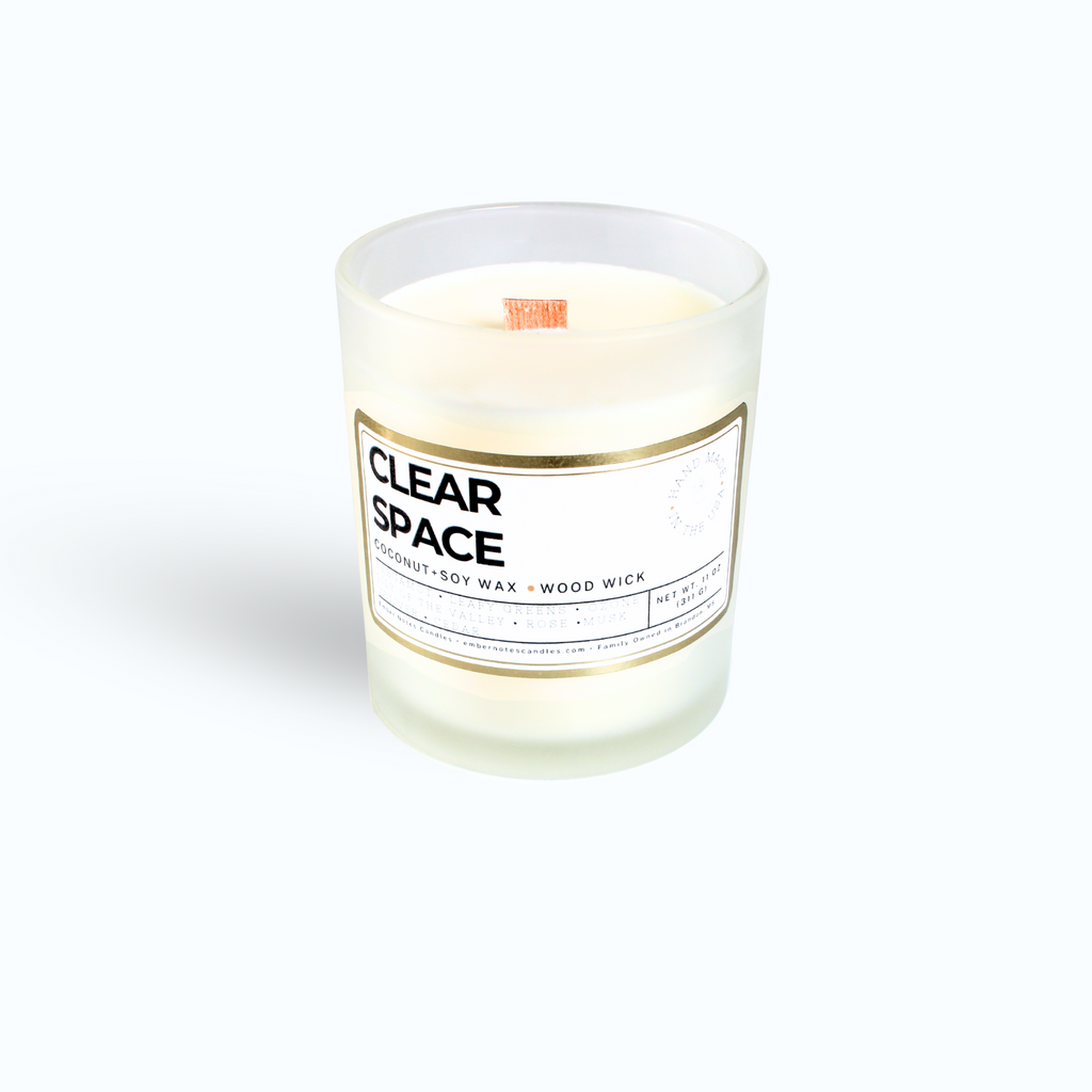Candle with clear space label on the front in front of a white background 