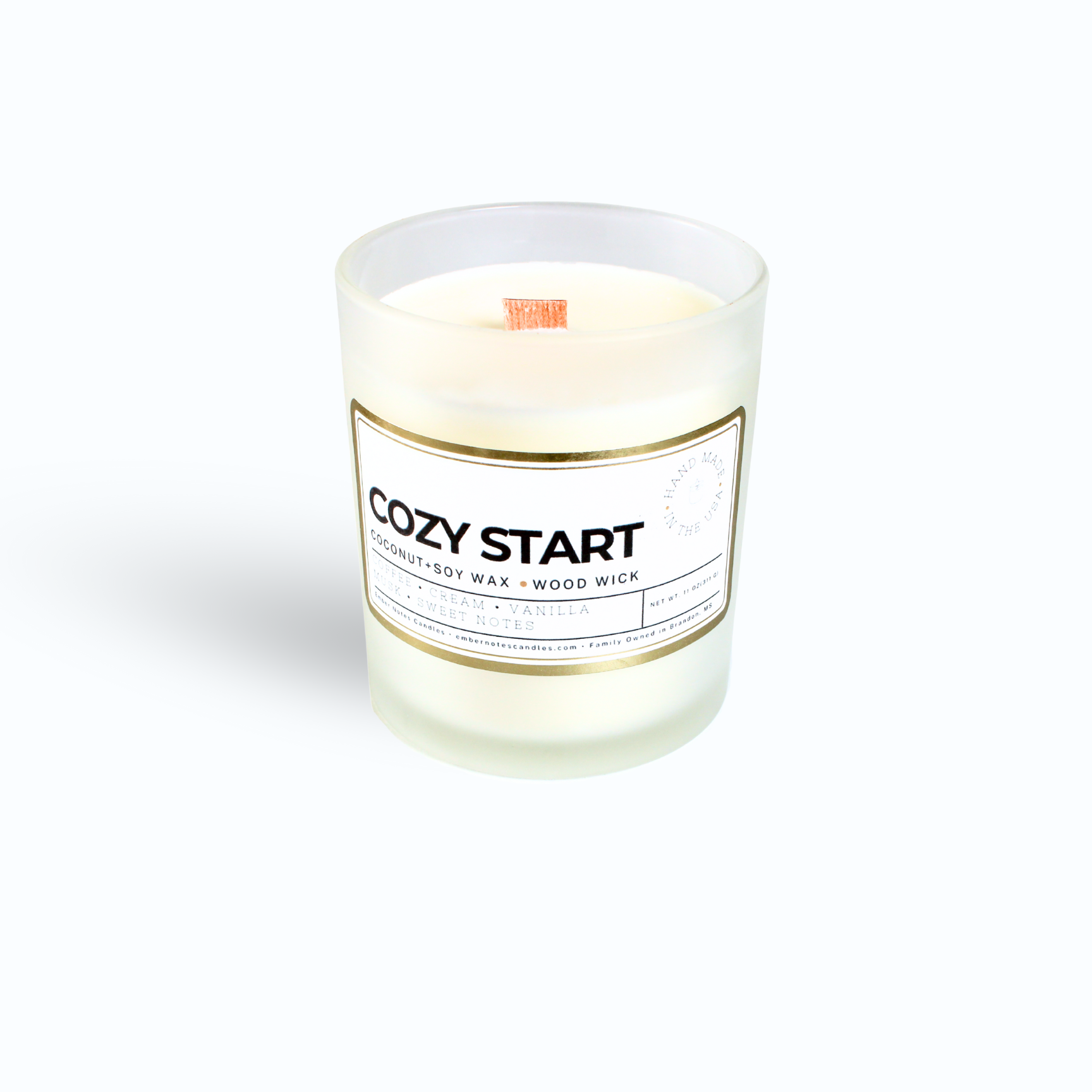 A candle with a label that says cozy start