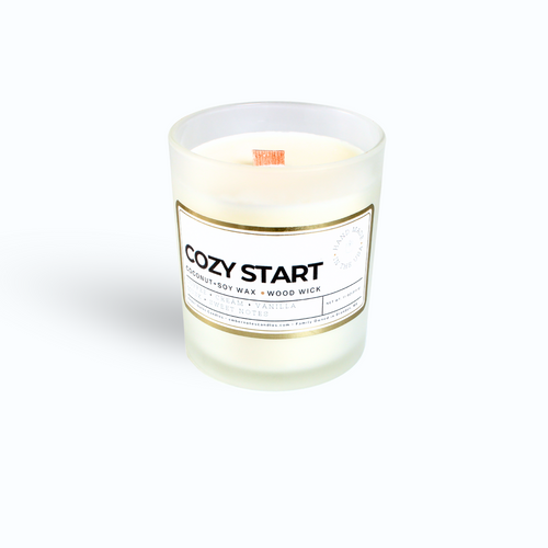 A candle with a label that says cozy start
