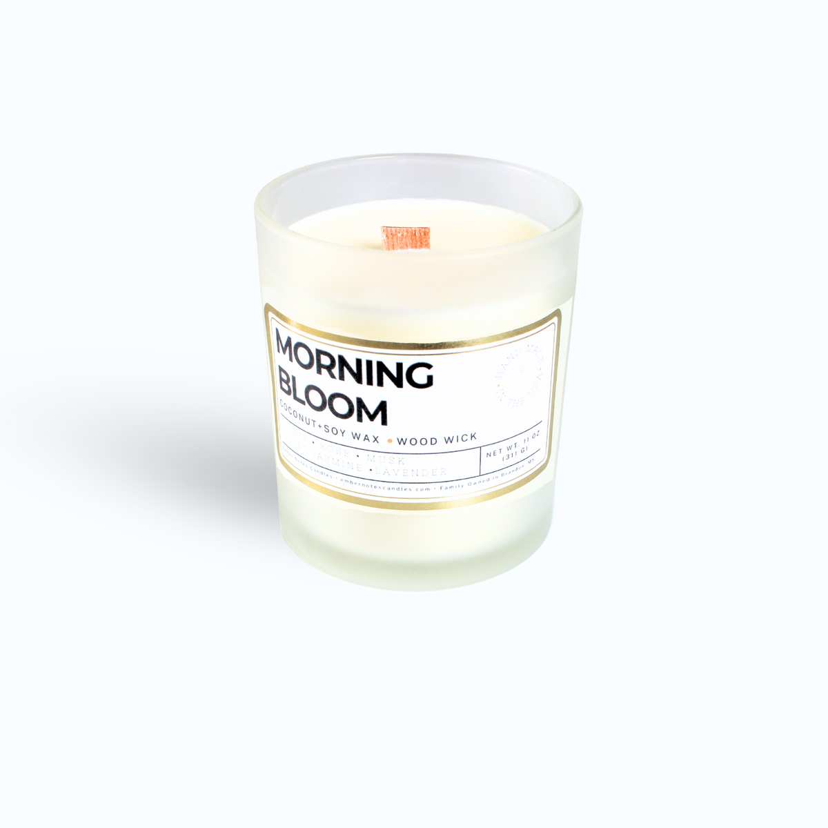 A candle with a label that says Morning Bloom