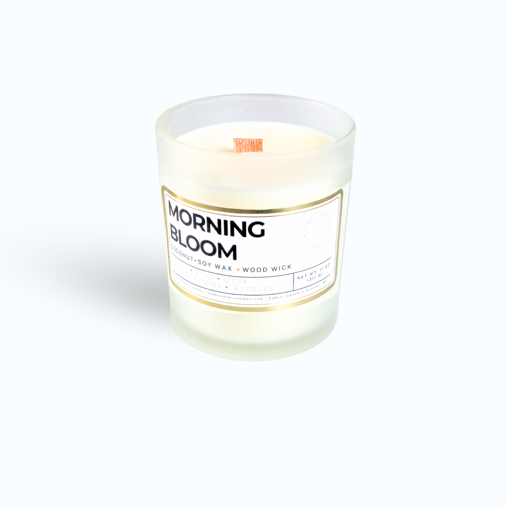 A candle with a label that says Morning Bloom