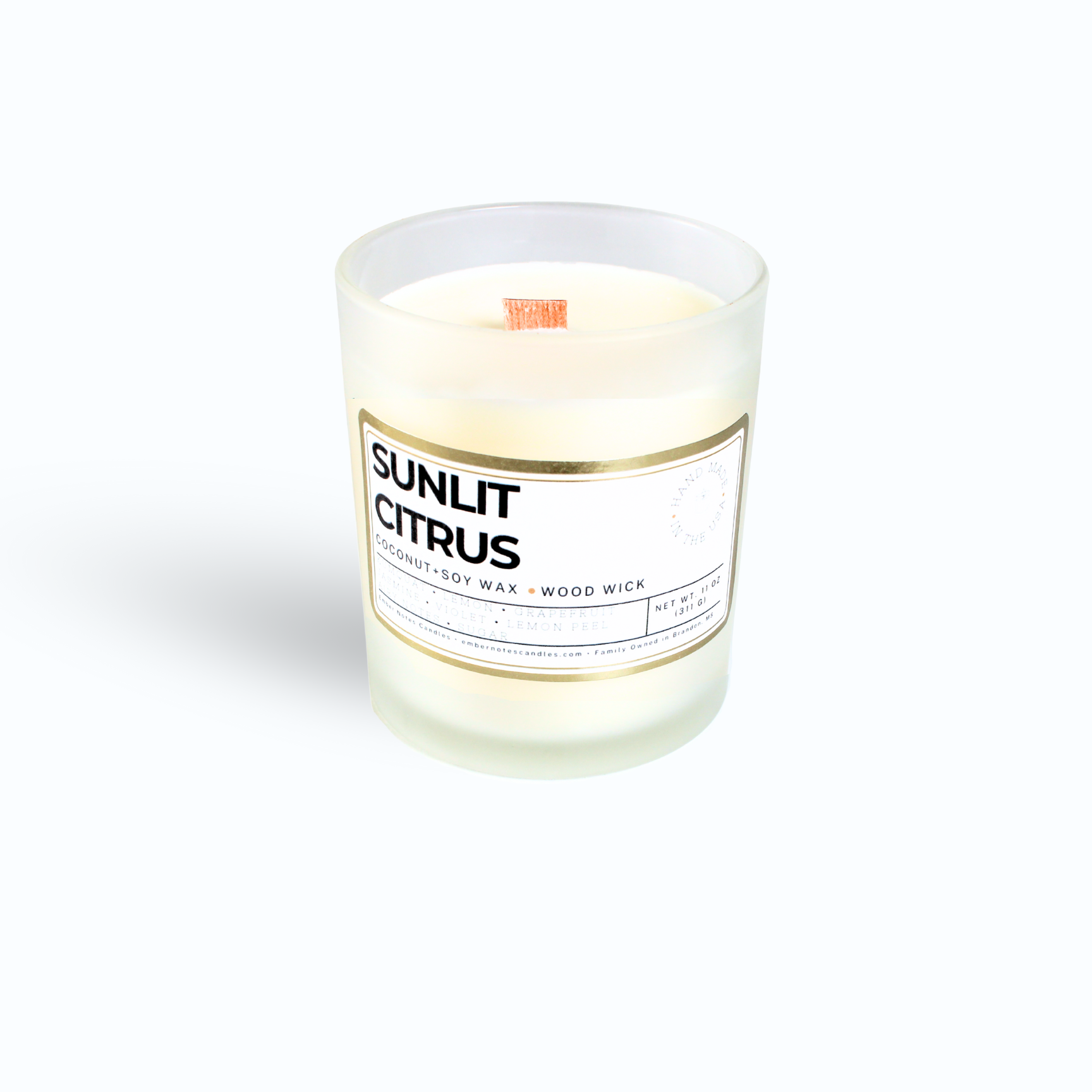 Candle in front of a white background with the label sunlit Citrus 