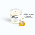 A candle with a label that says Warm Intentions