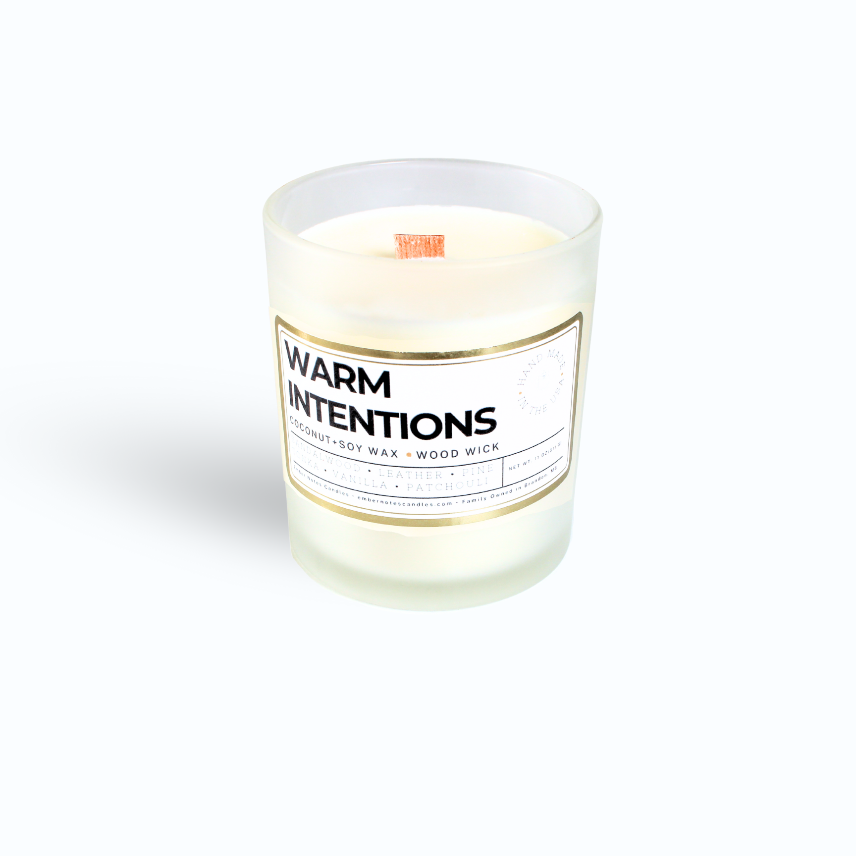 A candle with a label that says Warm Intentions